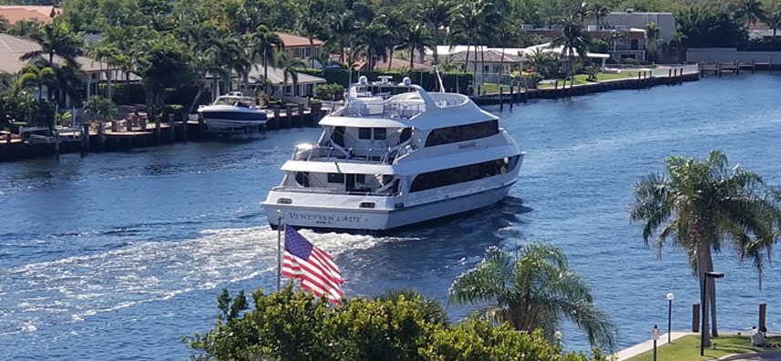 yacht cruising down a river